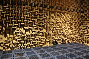 Image shows the inside of an anechoic chamber - metal grid floor with soft sponged walls