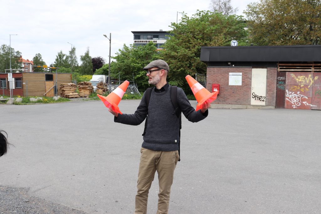 Images shows Trond Magg holding small traffic cones